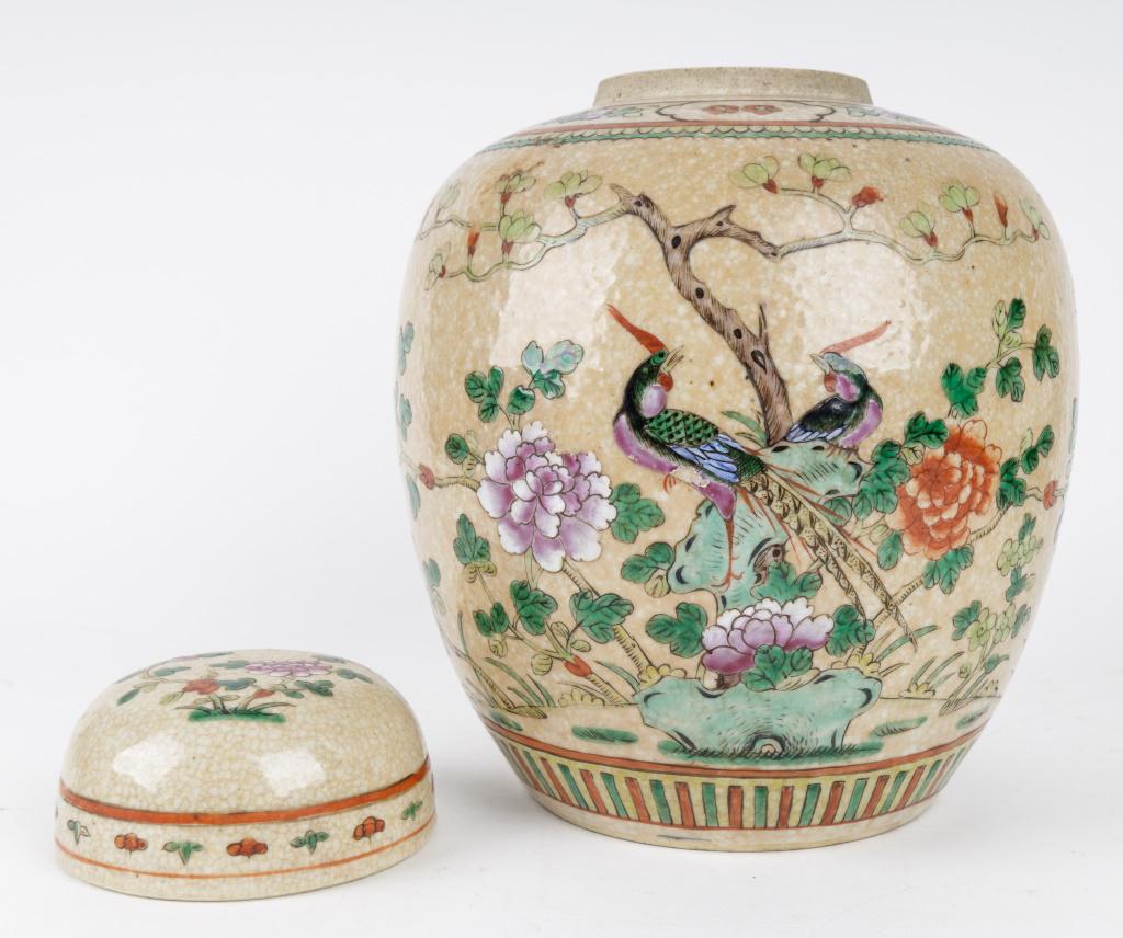 Chinese Porcelain Ginger Jar with Birds: This Chinese porcelain ginger jar is a tan color with hand painted design of flowers, birds, and insects. Measures approx 11 1/4" H (with lid) x 8 1/2" dia (at widest). There is some paint loss on one