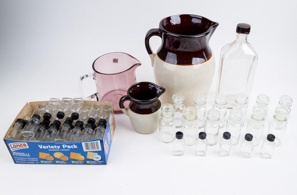 Vintage Stoneware & Glass Bottles: 2 brown and white stoneware pitchers, largest approx 10"H, Blenko pitcher, 32 oz unused bottle, approx 70 small medicine bottles 'Moderne' stamped bottles with lids, 4 bottles with stoppers approx 3.5