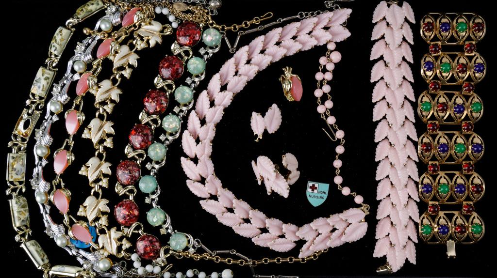 Vintage Coro and Estate Jewelry Collection: Four "Coro" including red lucite and gold tone and white leaf "Coro" necklace, "Coro" green confetti type necklace, and clear "Coro" mottled necklace (missing one stone). Early pink necklace, bracelet