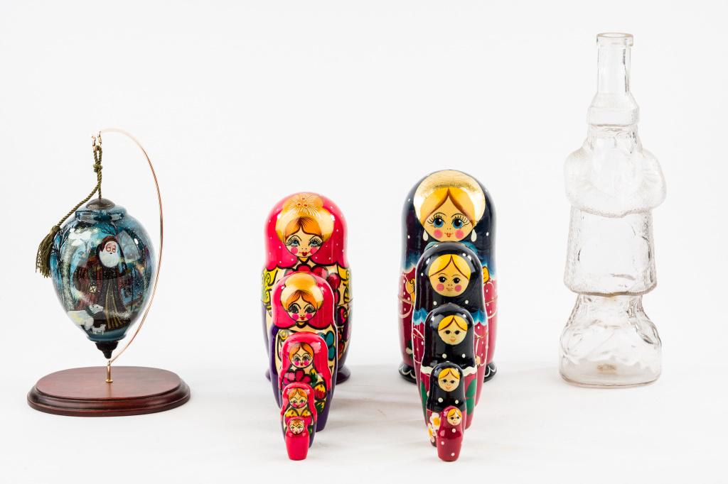 Christmas Decorations: With Ne'Qwa Art signed by artist 'D. Morgan' of Santa with wildlife, comes with display, Santa glass bottle approx 12.25"H, and 2 sets of 5 Matryoshka nesting dolls.