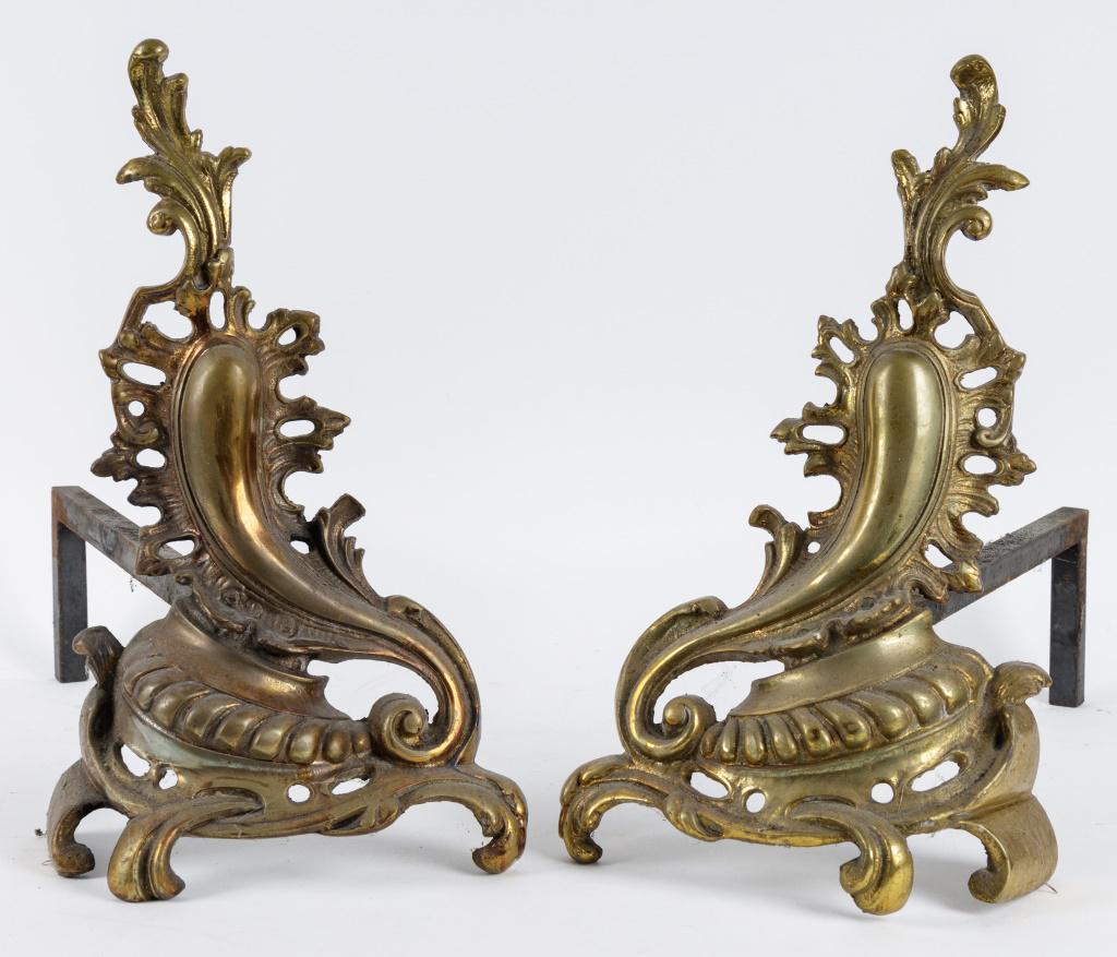 Art Nouveau Style Brass Andirons: Set of brass andirons, approx 15.5"H x 18.5"L. They are similar to decorative French style, looks similar to Louis XV style.