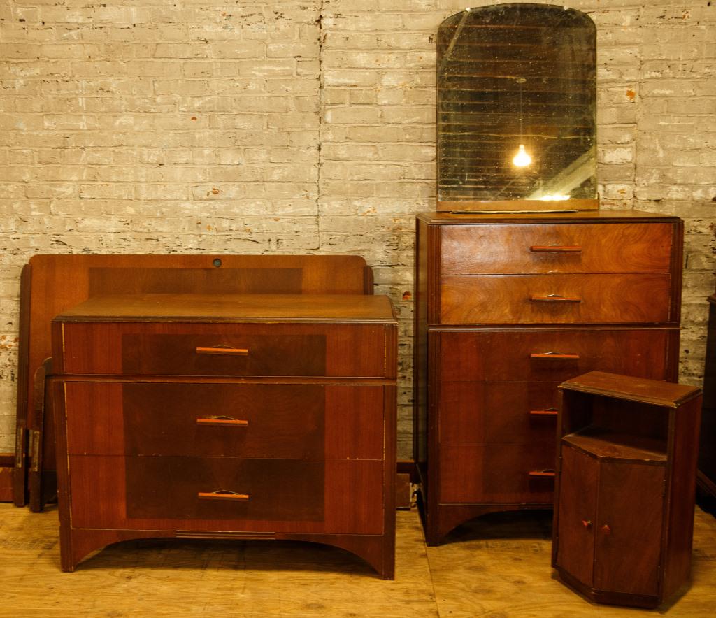 Art Deco Bedroom Set with Bakelite Handles: Suite includes a dresser, hanging mirror, night stand, an other dresser, and a bed. Bed measures 40" high x 56" wide x 78" deep. Tallest dresser measures approx. 46" high x 34" wide x 19" deep. Some s