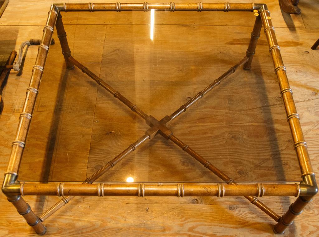 Designer Style Bamboo and Glass Coffee Table: Faux bamboo and glass top table measures 15" high x 39" square. Good condition with some wear.