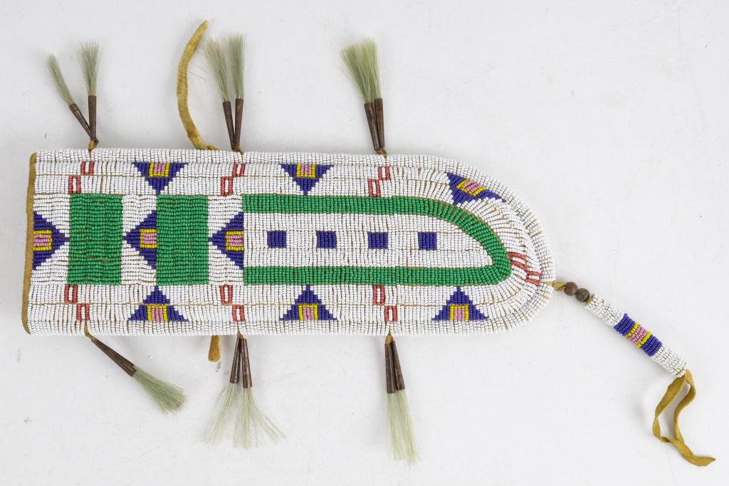Vintage Plains Indian Beaded Knife Sheath: Vintage Plains Indian beaded rawhide and leather knife sheath in very good condition, with metal tinglers holding what appears to be horse hair tassels, approx 11.5"L not including bottom tassel.