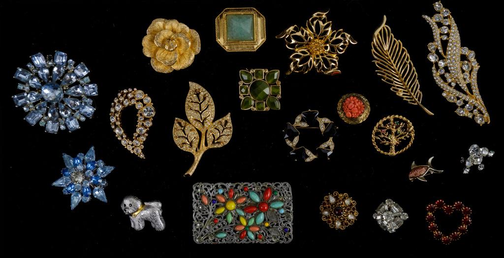 Dior and Vintage Estate Brooch Collection: Sampling includes signed "Dior" three floral and leafy gold tone crystal brooches, "Swarovski" clear crystal, "Trifari" feather and various other brooches.