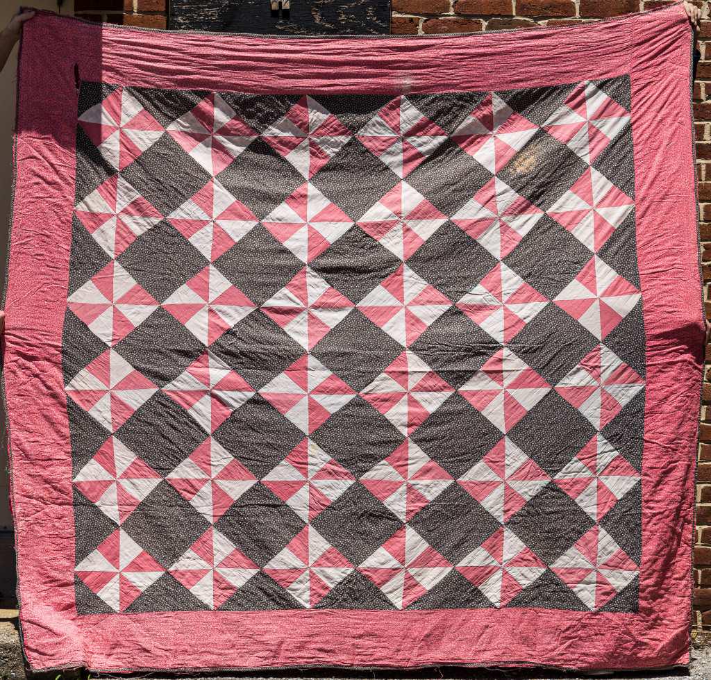 Vintage Handmade Quilt Blanket: Vintage handmade quilt blanket from York County PA Estate, in pinks, blacks, reds and whites, approx 85" x 95", has loss, sold as seen in photos.