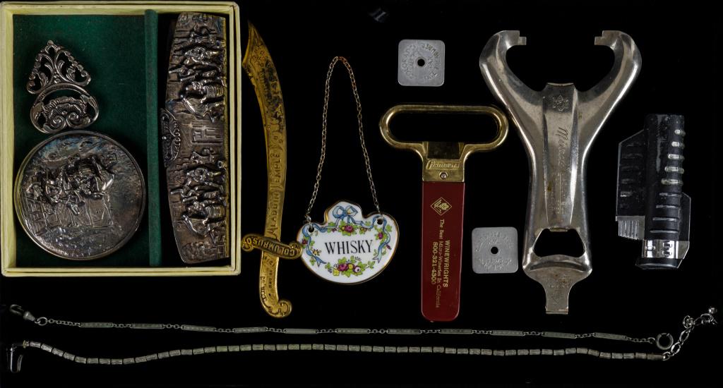 Masonic, Silverplate, Tokens & More: Masonic letter opener sword dated 1910, Trifari necklace, silverplate comb and matching hand mirror marked 'Made in Holland', 2 Colorado sales tax tokens, advertising bottle openers, Staffordshire Eng