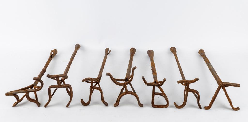 Antique Blacksmith Made Branding Irons: 7 Antique blacksmith made branding irons (missing wood handles) with various brand marks, 4 with twisted handles and 3 without, approx 18.5"L, corrosion commensurate with age and use.