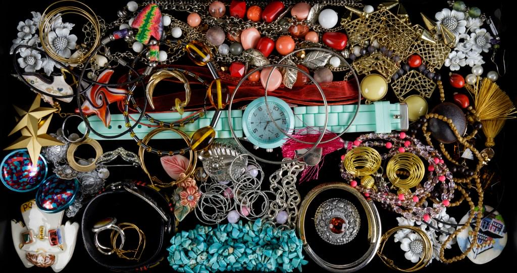 Mixed Costume Jewelry Group: Group of bracelets, necklaces, pins, earrings, and more, featuring a stretch howlite bracelet, a rhinestone Mardi Gras mask pin, a hand painted shell pin from Martha's Vineyard, and a hinged gold tone