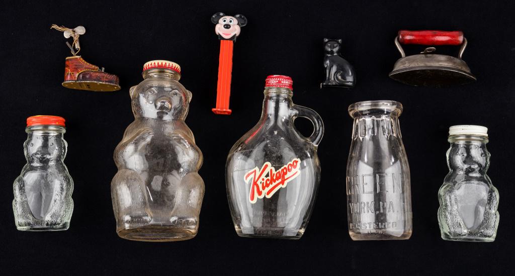 Vintage Bottles, Pez & Toys: Vintage bottles including bear bottles, largest 'Snow Crest Bank Bottle' approx 7.25"H, Rock Creek Kickapoo bottle, and Green York PA half pint bottle, Mickey Mouse Pez dispenser, black cat tape measu