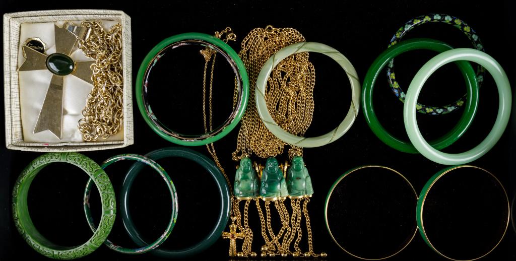 Real & Faux Jade, Trifari Jewelry: 2 Trifari bracelets in gold tone and green with copyright symbol through 1955, 3 Buddha faux jade necklace marked Trigere, genuine jade cabochon in large 3" cross with chain, enameled bracelets, and m