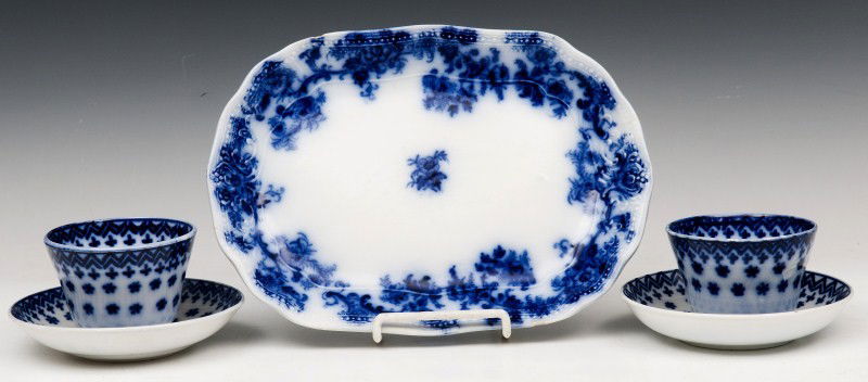 English Flow Blue Platter, Cups and Saucers: An English flow blue platter and 2 snowflake pattern handleless cups and saucers