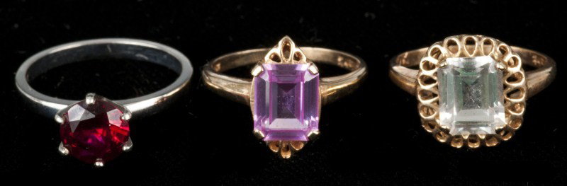 Three Gold Rings: 3 Gold rings including 10K wg with a synthetic ruby, a 10K yg with a synthetic ruby and a 10K yg with a colorless spinel, 4.0 dwt