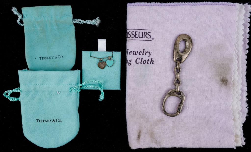 Sterling Tiffany & Company Necklace, Keychain: Tiffany & Co. marked sterling silver heart necklace on Tiffany & Co. sterling chain, and 2 small bags, and JLD TAS marked 950 sterling keychain, approx 22.0 DWT.