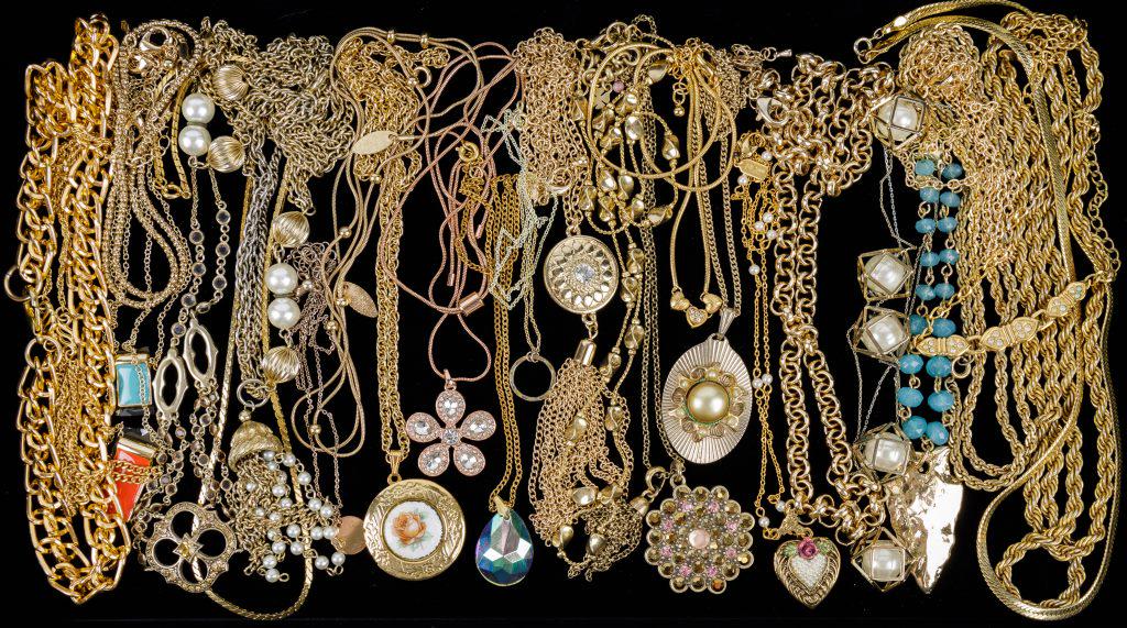 Gold Tone Necklaces: 26 Gold tone costume necklaces featuring an Avon triple heart, Celebrity NY triple strand accent, enameled flower locket, 1928 heart locket with faux pearls, jellyfish pendant with faux pearls, Premie