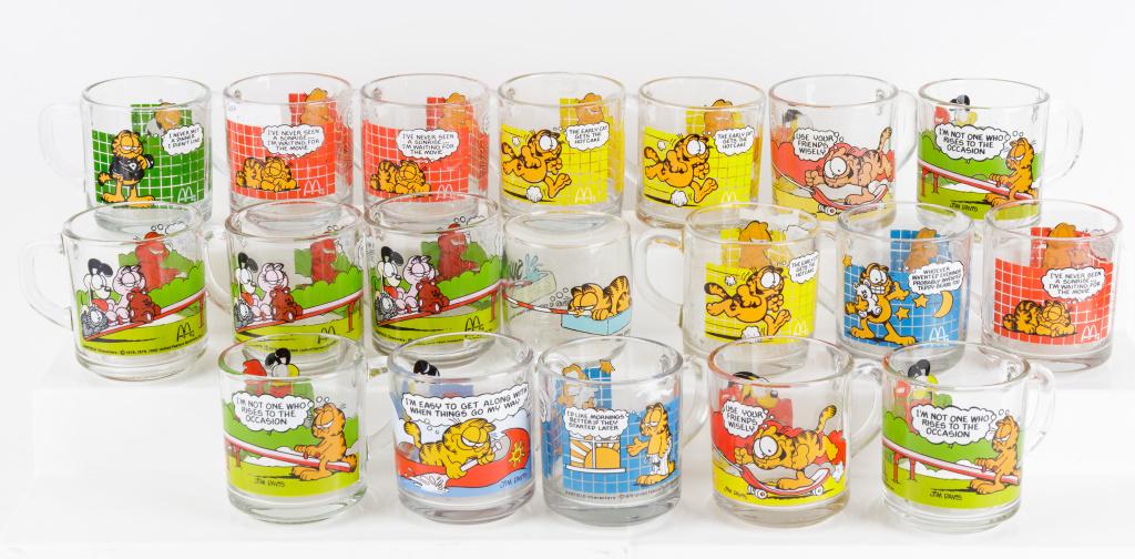 Vintage Glass Collectible Garfield Mugs: 18 collectible glass Garfield mugs and one other Garfield drinking glass.