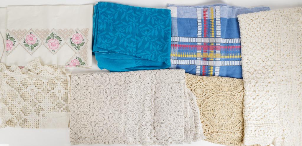 Vintage Lace & Other Tablecloths: 3 Lace tablecloths in cream and ivory, 1 embroidered table cloth, floral blue oval tablecloth, and Amrajoth tagged hand woven in India 100% cotton tablecloth.