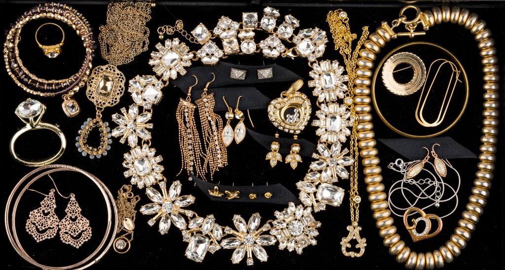 Nolan Miller, Noir and Costume Jewelry: 23 items of gold tone costume rhinestone jewelry featuring a Nolan Miller heart pendant, Noir earrings (square pyramid shape), Avon drop earrings, pins, necklaces, bracelets and 1 ring.