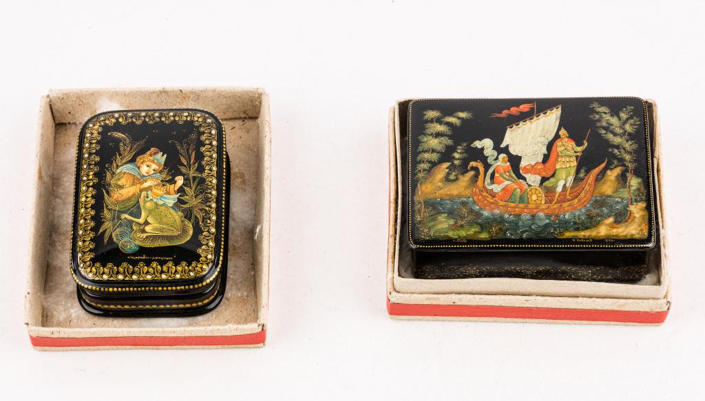Palekh Russian Lacquer Boxes: 2 Signed Palekh Russian lacquer boxes, lift lid box dated 1992, has couple on ship, approx 4"L x 3"D, and 'Frog Princess' hinged box 2.5"W x 3.5"D and signed on bottom, has some hairline cracks to lac