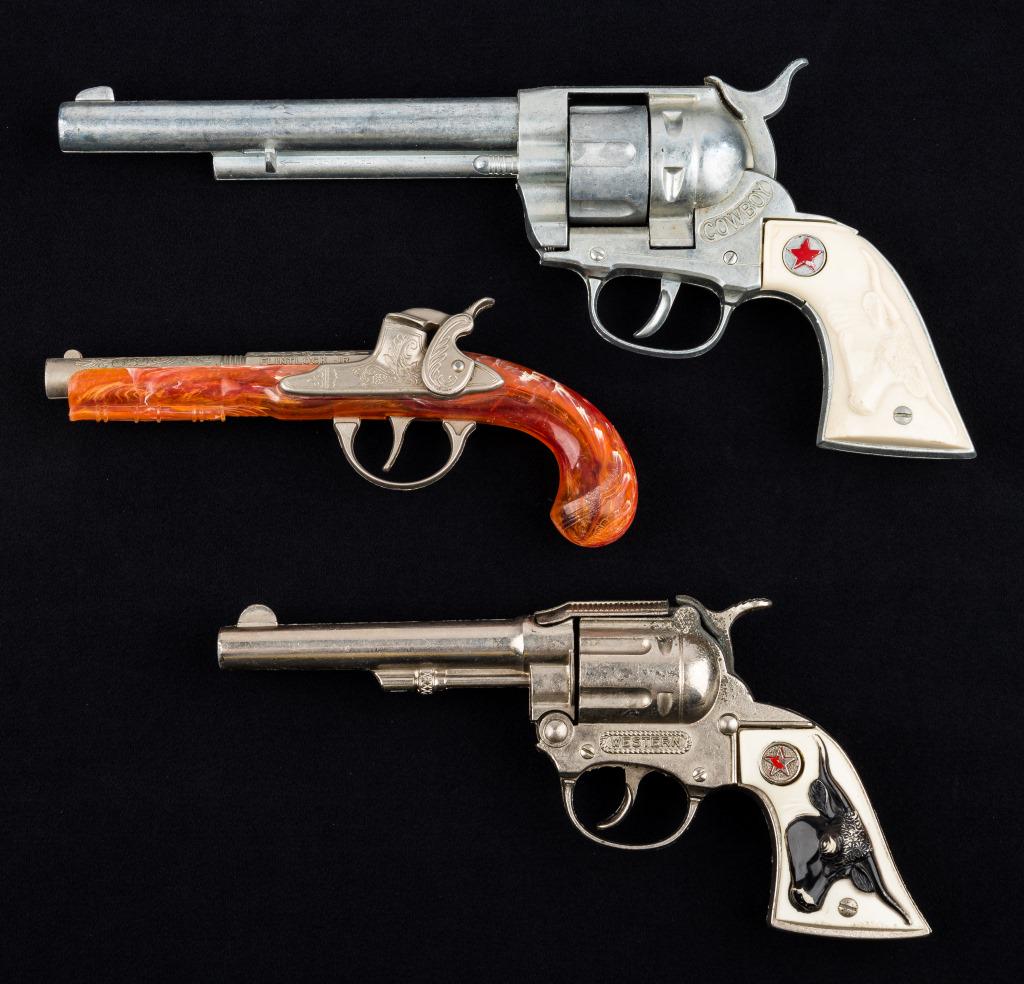 Toy Revolvers / Cap Guns (3): Cowboy cap gun approx 12" L and Hubley orange cap gun (both good action), Western cap gun with steer on handle (action a little rough).