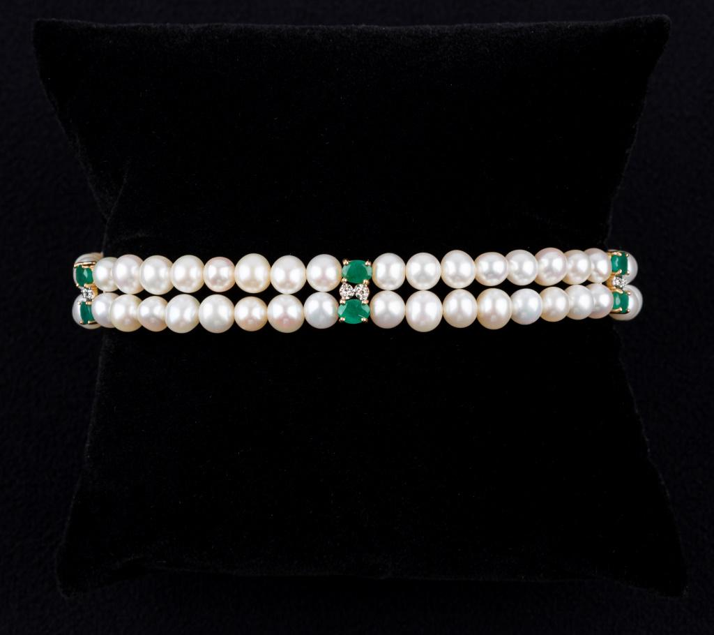 14K Gold, Diamond, Emerald and Pearl Bracelet: Very fine diamond, emerald and double strand pearl bracelet with a 14K gold clasp. 7 inches in length.