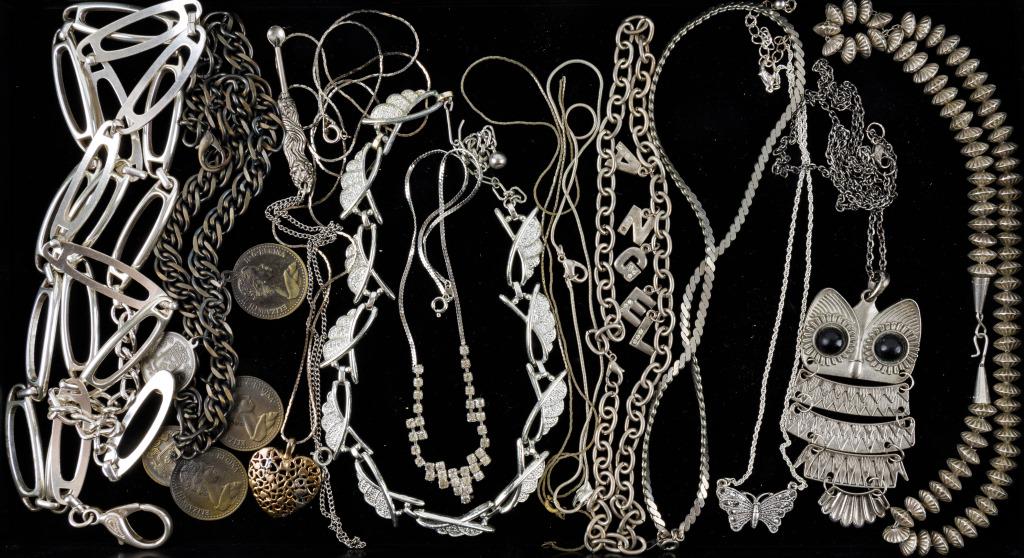 Silver Tone Costume Jewelry: Variety of silver tone costume jewelry including large owl pendant, marcasite butterfly, coin necklace, Art Nouveau style pendant, rhinestone, 'Angel' necklace and more.