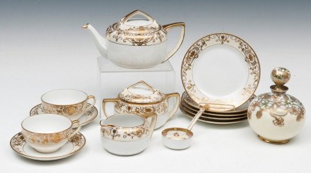Partial Noritake Porcelain Service: Partial Noritake porcelain service including (5) 6 1/2" plates, two cups and saucers, tea pot, covered sugar, creamer, ladle and like patterned dresser bottle and stopper