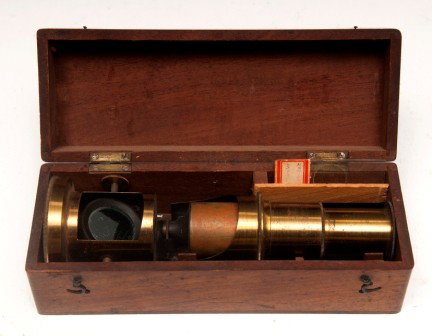 Early Microscope: Early portable microscope in original box, includes one slide and tool