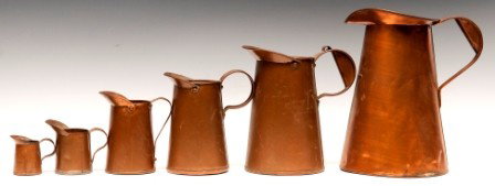 Six Graduated Copper Pitcher form Measurers: Six Graduated Copper Pitcher form Measurers with applied handles, tallest 10 3/4"h