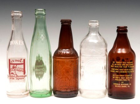 Early Soda Bottles: Early soda bottles including a Pepsi 1976 Father of Our Country bottle, Sarsaparilla Sioux City soda bottle, Hokes Quality Beverage bottle, Royal Crown Cola bottle and My Pops Root beer bottle
