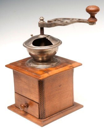 Inlayed Oak Coffee Grinder Early 20th C: Inlayed oak coffee grinder with an ornate, cast and pierced handle, oak case with chamfered and inlayed corners and one drawer; 11"h x 5 1/2"sq