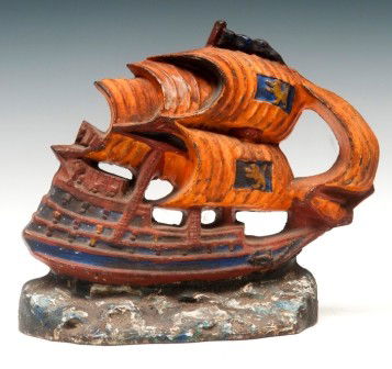 Ship Door Stop: Cast iron sail ship door stop, orange and blue paint, 10"x9"