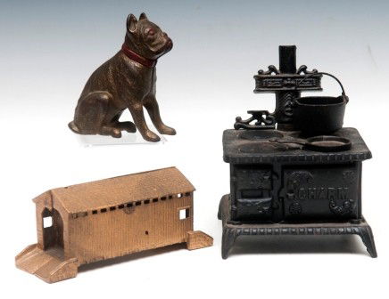 Cast Iron Bank Lot: "Charm" kitchen stove bank with two cooking pots, black paint; one bull dog bank gold and red paint and one gold paint covered bridge