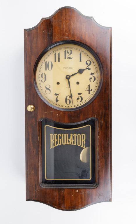 Verichron 31 Day Regulator Clock: Verichron 31 day regulator clock, made in USA, approx 30" H x 13" W. Fair condition with some surface scratches. Has pendulum, No key. Untested.