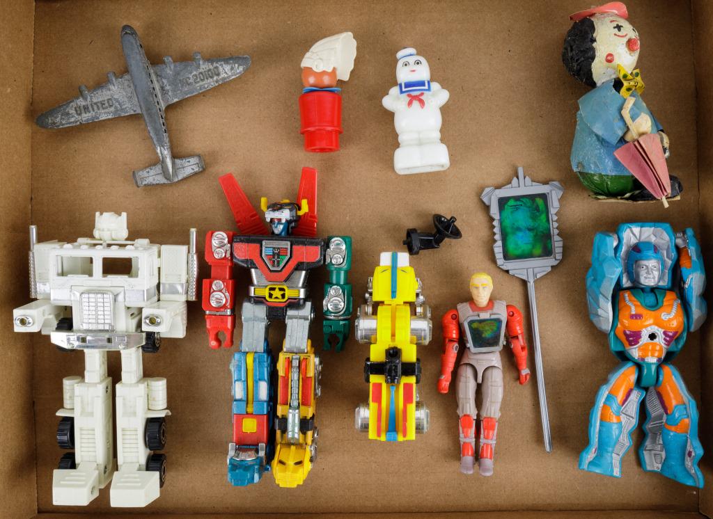 Vintage Transformers Figures and More: Vintage Transformers figures, 2 other action figures, 1 airplane (has damage, missing wheels), Fisher Price, 2 accessories, Ghostbusters pencil sharpener, Vintage paper mache clown.