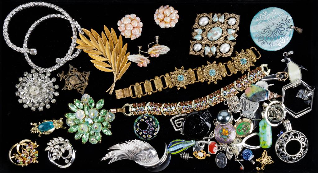 Trifari, Lisner, Vintage Jewelry Group: 52 pieces of vintage jewelry including a Lisner brown and blue rhinestone bracelet, Trifari silver tone swirl brooch, large green and goldtone brooches, clip earrings, charms, pendants, owls, shells,