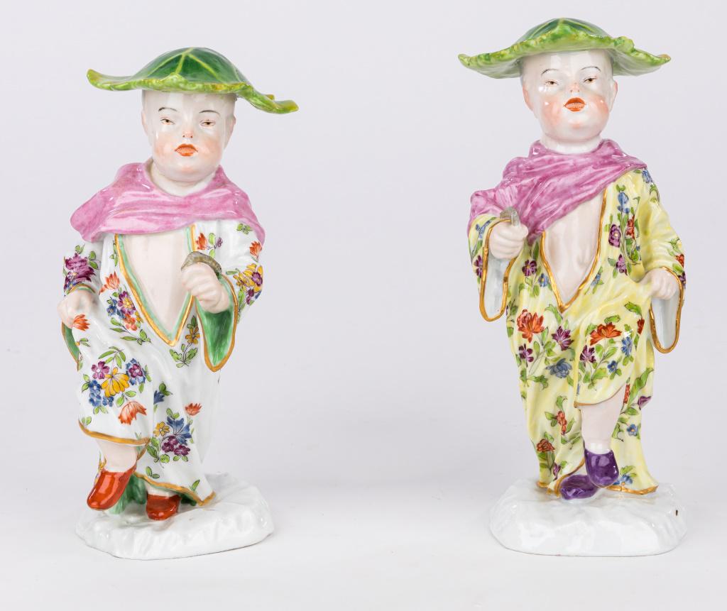 Pair Meissen-Style Figurines by Kaendler: Pair of Meissen-style Samson Chinese boys with hats made from cabbage leaves . Original model designed by Joachan Kaendler in 1745. There are restorations to one figure's head and hat area and both ar