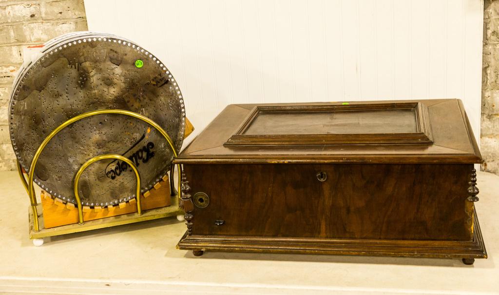 Kalliope Tabletop Music Box: The Tabletop music box plays 17.5" discs. It includes 33 discs and a stand. It has a single comb and has a mahogany/ veneered case (some loss), it has a key and a crank.