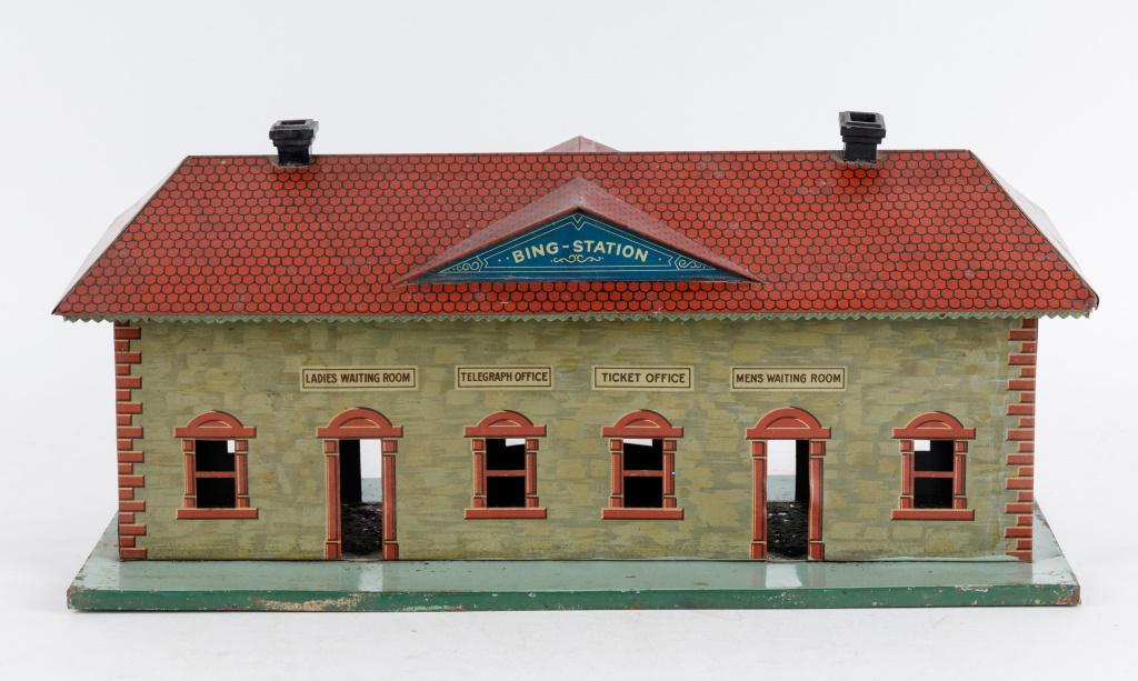 Antique Tin Litho Train Station: Antique tin litho train station "Bing Station" with removable roof, friable paint on the inside, minor paint loss on the outside, minor dents & dings, overall good condition, size 20" x 9".