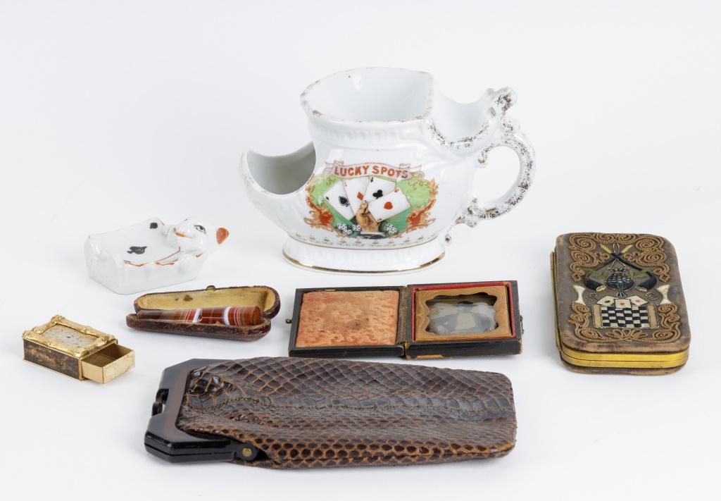 Antique Gambler's Cigar Case & Accessories: Leather embroidered gambler's cigar holder (loss to the inside lining), gambler's shaving cup (approx 6" L), tin type photo of man smoking cigar in frame, Japanese porcelain cat with cards, bamboo gol