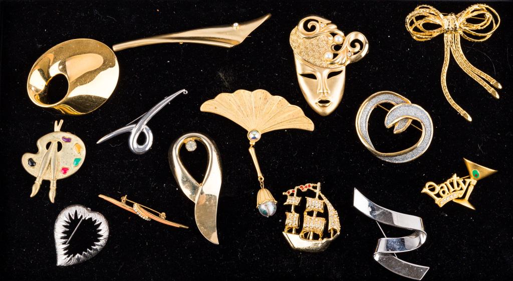 Modern Theme Brooches (14): There are 14 large modern theme brooches including a few with names such as Danecraft, Monet, JJ. Brooch with face measures approx 2 3/4" L. Please see photos.