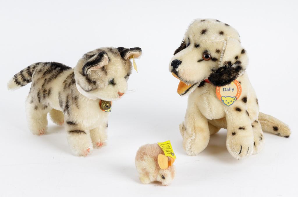 Steiff Dog, Cat & Rabbit Stuffed Animals: Three Steiff animals including Dally dog (#3317), Tabby cat (1314-0) and a small rabbit (250442). Dog measures approx 7 1/4". All in good condition with slight loss behind cat's left ear.