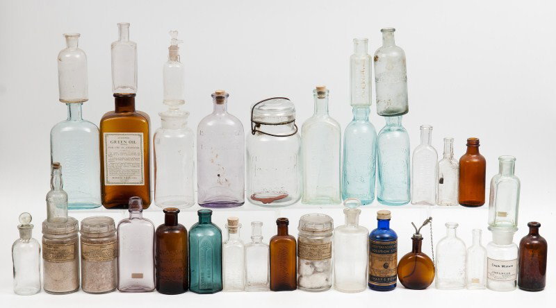 Large lot of Medical Bottles: Large grouping of medical and chemist bottles, most colored glass; from the L.H. Bohning Collection