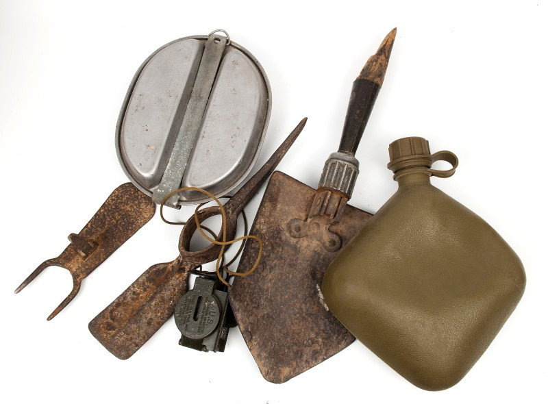 US Military Field Gear: Including a magnetic compass, mess kit, trench shovel, civil war era pick ax marked US along with another pick ax head with traces of gold in alloy and a later water bottle