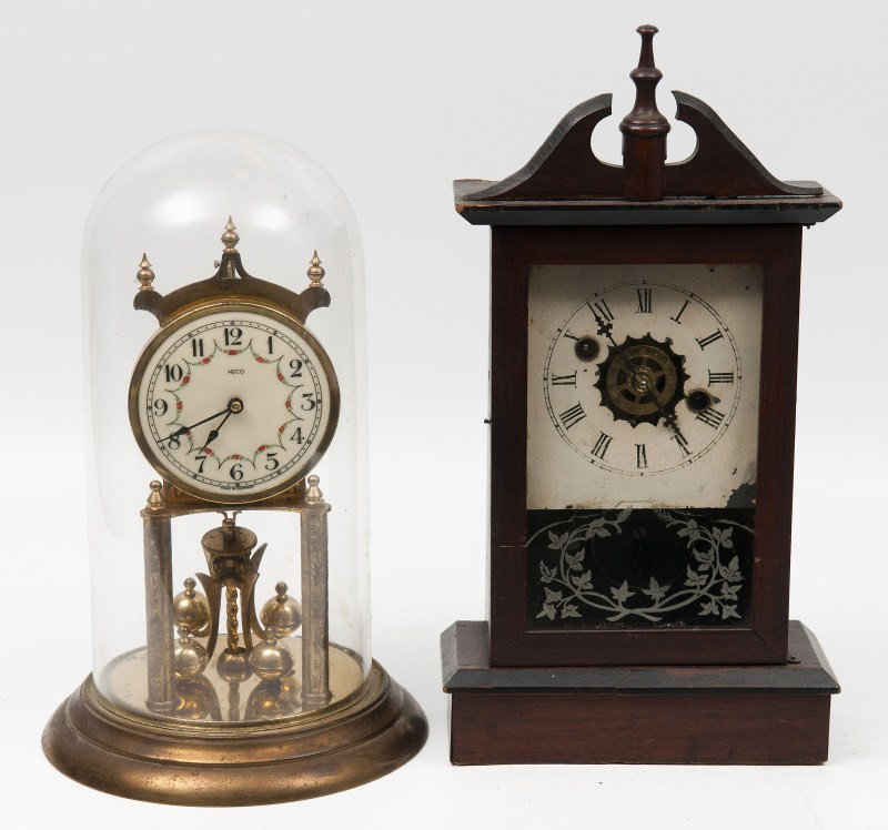 Two Early Mantle Clocks: German glass domed porcelain faced clock, ball swing movement with another mantle clock, tallest is 14 1/2"h