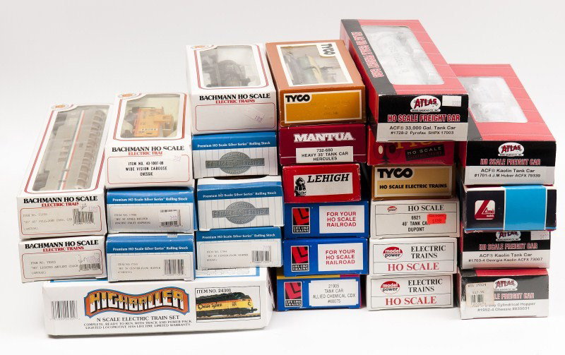 Twenty Six Bachmann, Atlas, Tyco, Life Like, Model: Bachman High Baller partial set containing engine caboose, box can and flat car, also with two Amtrak passenger cars, five box cars, tank car and a caboose, also with four Atlas tank cars, two Life Li