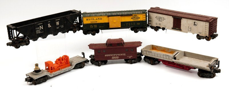 Lionel Cars and Track: Six unboxed Lionel cars including two box cars a hopper and three others; also included is various track; all in as is condition; see photo for complete description