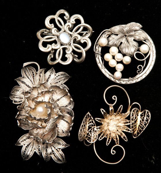 Four Silver Brooches: Two marked "Silver", two unmarked. Includes two spun silver florals and two other florals, two set with pearls, one moonstone, 1.66ozt total