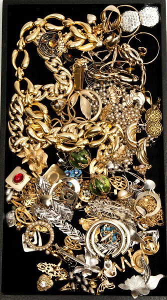 Costume Jewelry: Large grouping of gold-tone jewelry including hoop earrings, necklaces, pins along with two large silver-tone brooches, one marcasite bow and one Sara Coventry pinwheel style