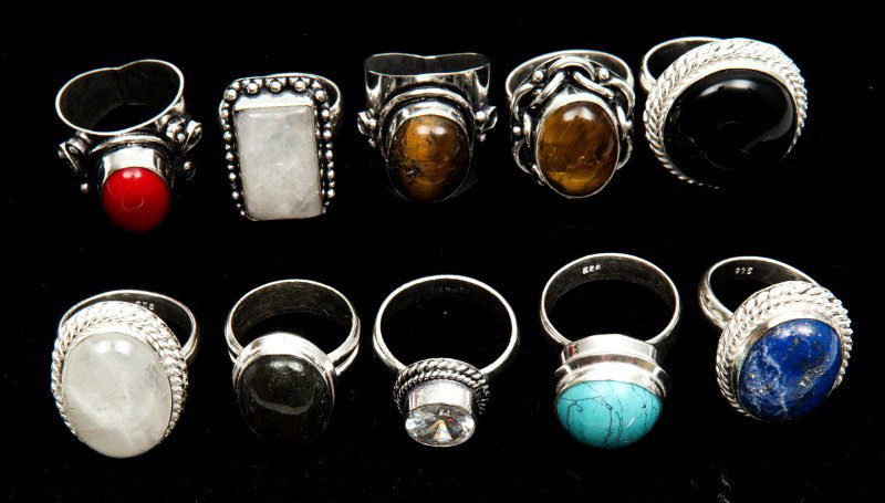 Ten Sterling Rings: Containing various cabochons and faceted stones such as labradorite, lapis, tiger eye, black onyx and glass, 3.19ozt